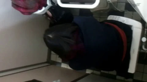 Teen Asian Girl Sits on Toilet in Bathroom