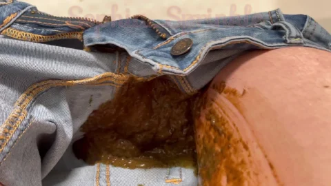 Blonde shits in shower while pulling down jeans from behind