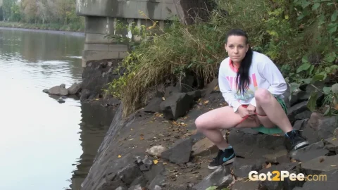 Athletic mixed race girl posing by a ruined bridge