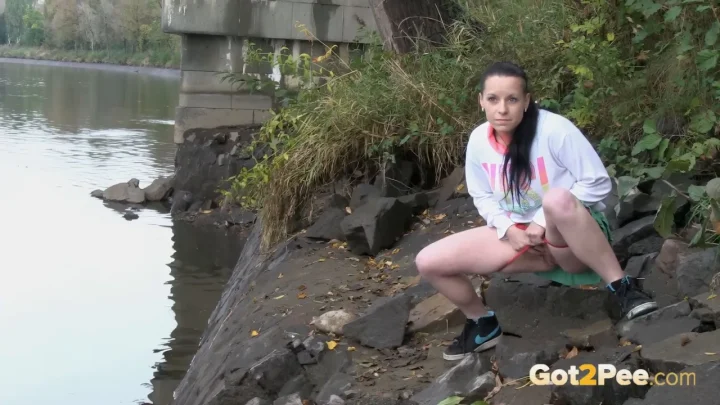 Athletic mixed race girl posing by a ruined bridge
