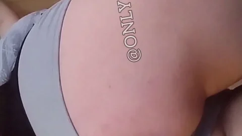 Brunette in white bra teases big tits in bedroom close-up