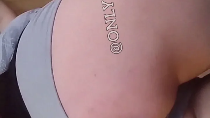 Brunette in white bra teases big tits in bedroom close-up