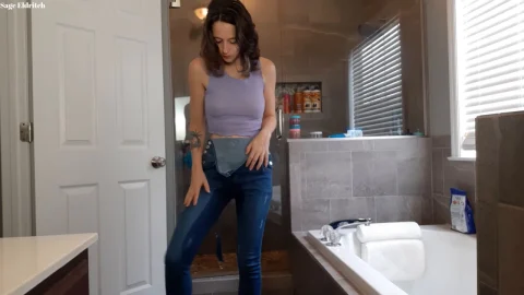 Woman in Overalls Adjusting Clothes in Bathroom