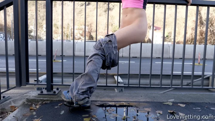 Brunette does piss play on city balcony, ass hanging over railing