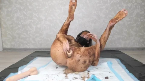 Brunette Slim Girl Covered in Brown Stuff Doing Solo Act on Mat