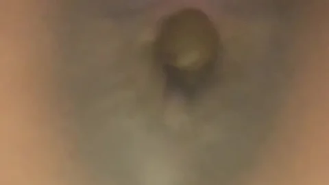 Black woman in bed doing close-up self-touch