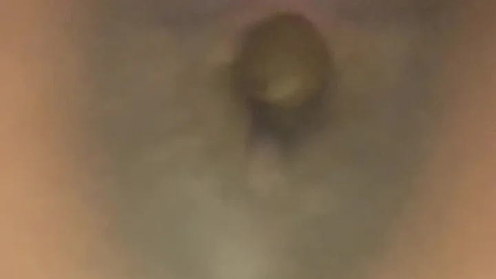 Black woman in bed doing close-up self-touch