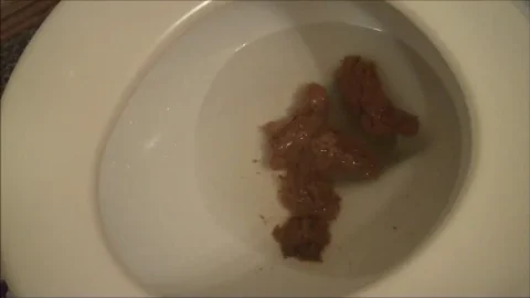 Slim girl squats and sits on toilet, pooping and straddling in dim bat