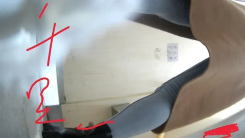 Asian woman with black hair and tattoos explores bathroom