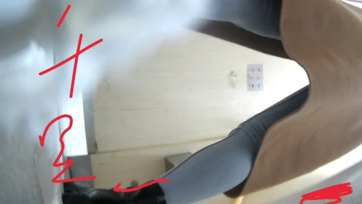 Asian woman with black hair and tattoos explores bathroom