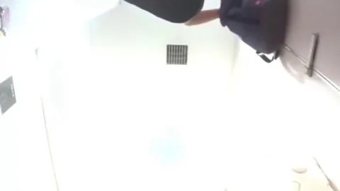 Asian Woman Urinating in Bathroom