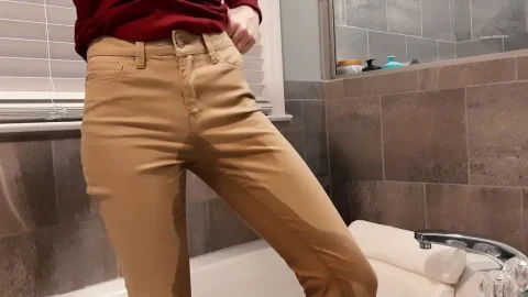 Slim redhead in red shirt teases from behind in bathroom